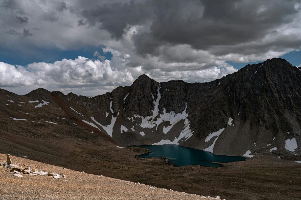 Stunning view of snow-capped mountains and a serene alpine lake in Skardu, Pakistan.